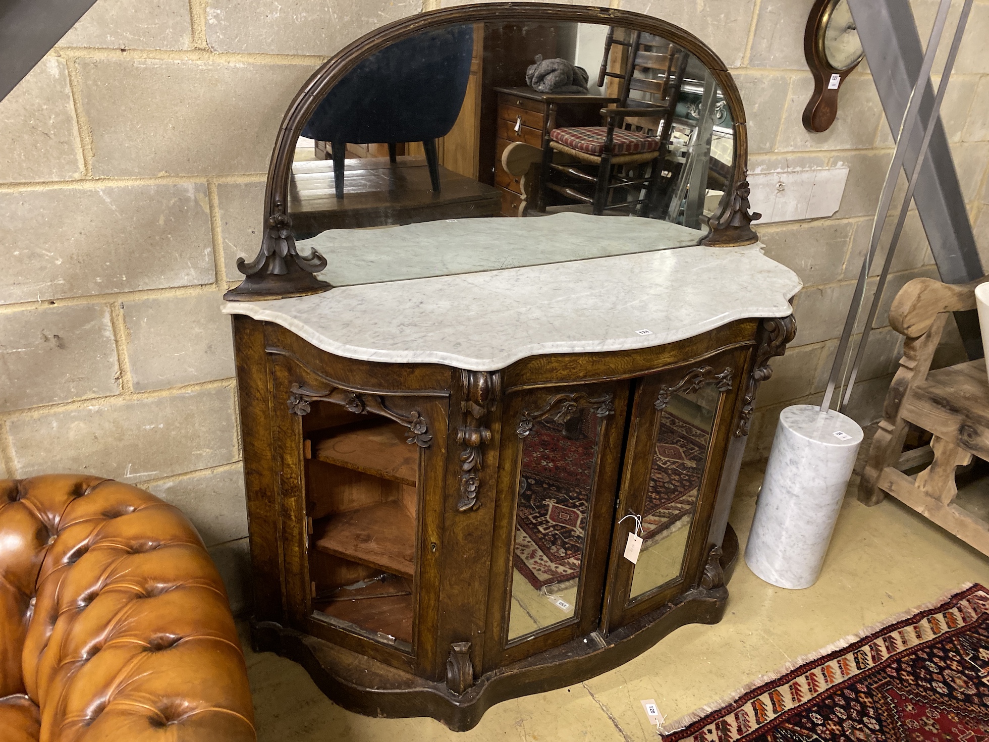 A Victorian oak mirrored back marble topped serpentine sideboard, width 150cm, depth 48cm, height 150cm